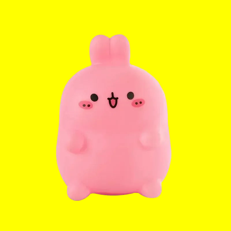 Pink cartoon-like figure with a simple face on a yellow background