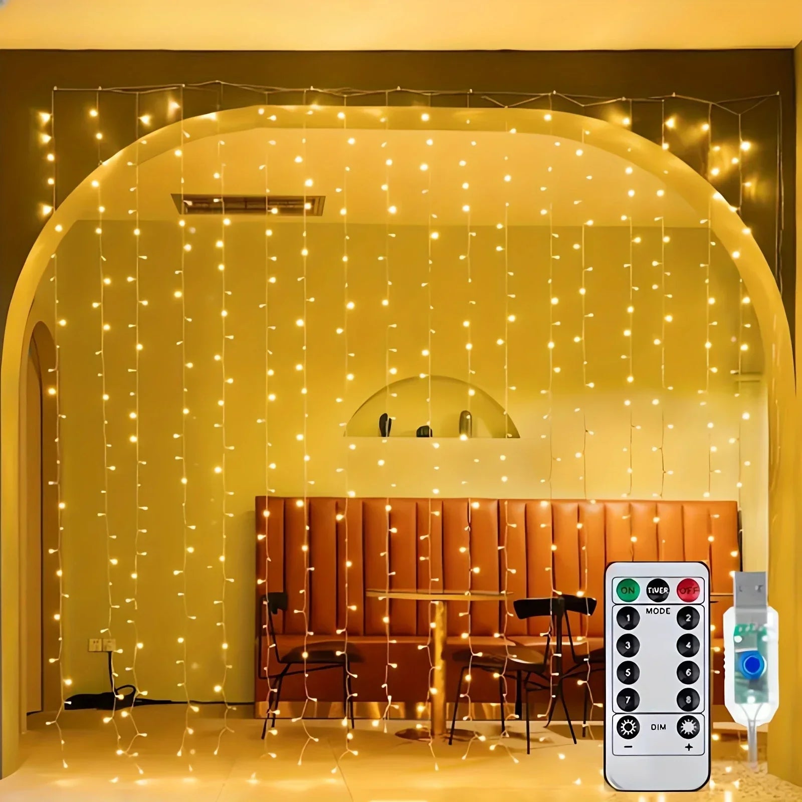 Indoor setting with string lights draped over a archway, remote control on the right.